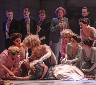 Sarah Richmond in the role of Olga is seen laying fainted on the floor, her mother fanning her surrounded by concerned looking men and women