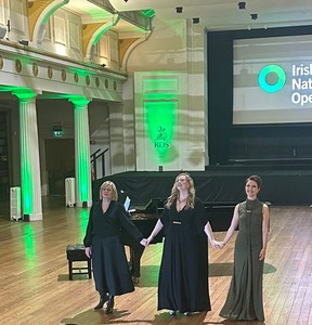 Pianist Aoife O Sullivan, soprano Jennifer Davis and Sarah Richmond stand hand in hand in front of a grand piano receiving a standing ovation